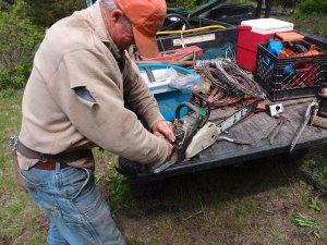 Mike managed to break the trigger on his chainsaw.  He's doing his best to field repair it with a makeshift trigger.